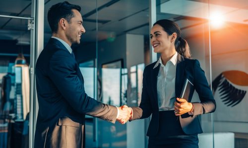 business-people-shaking-hands-front-window